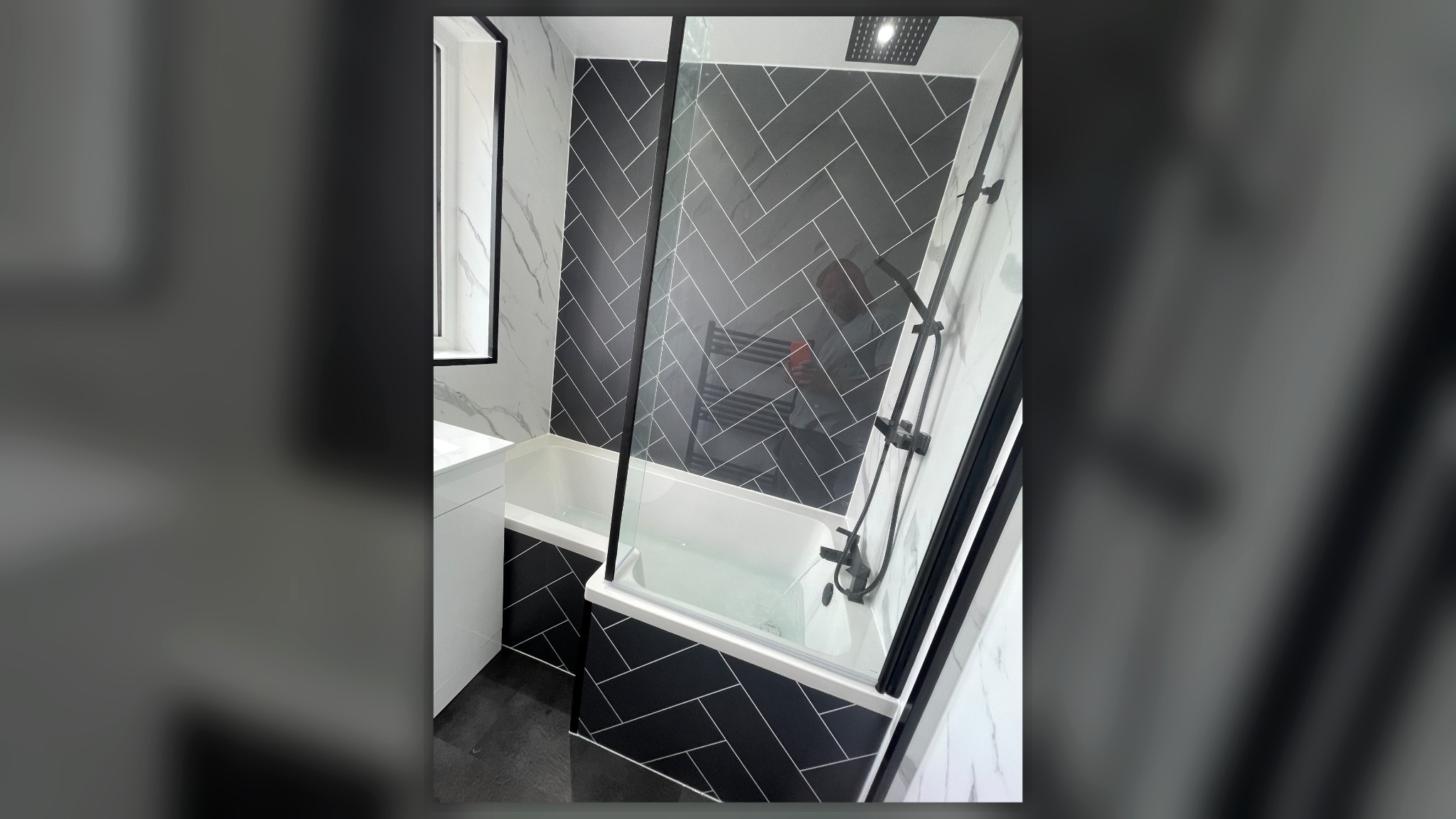 Modern bathroom with black herringbone tiles